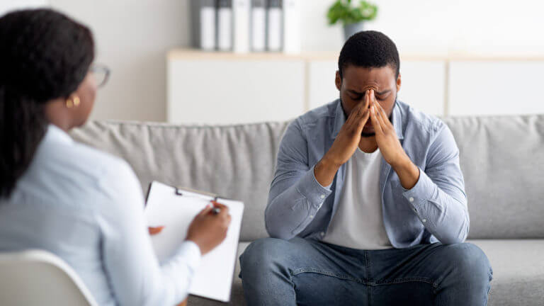 Desperate man suffering from mental health issues is having session at psychiatrist's' office.